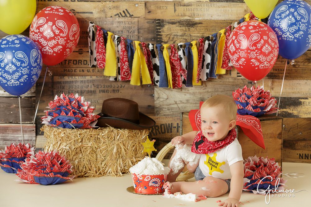 Cowboy Cake Smash, themed portrait shoot, photography studio props, streamers, bandanna, baby, outfit