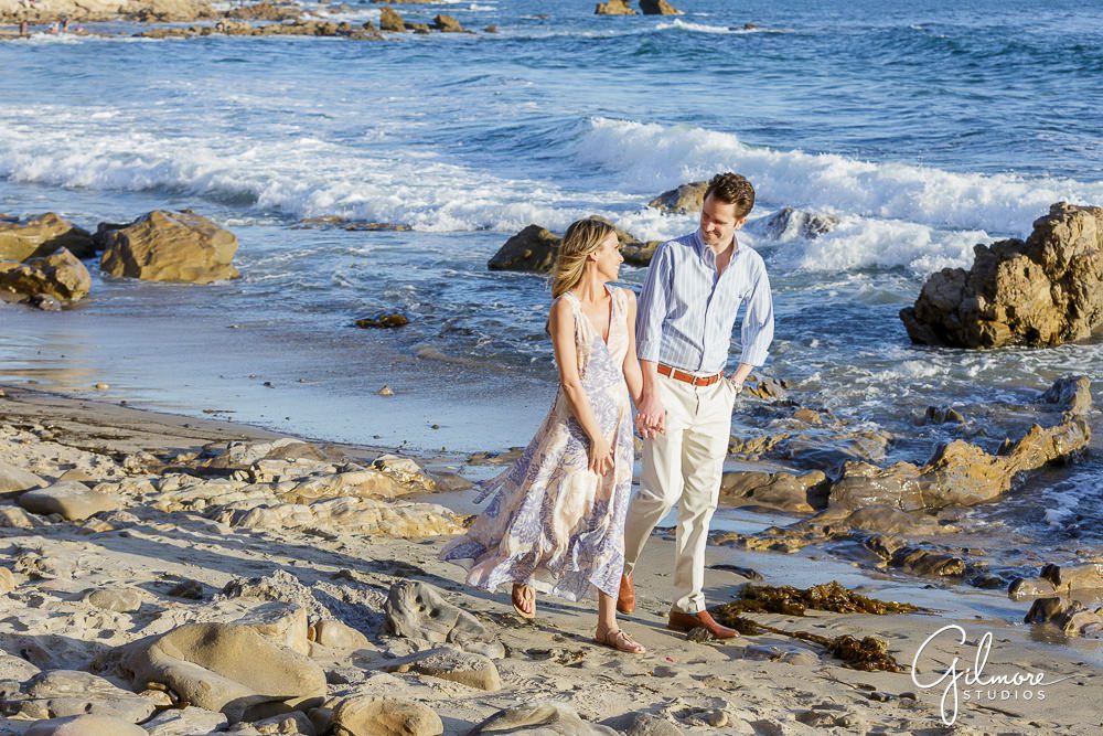 Newport Beach Engagement Session, waves, ocean, rocks, sand, walk, holding hands, engaged couple, poses, locations, little corona del mar, outfits, southern california lifestyle, natural light portraits, sunset
