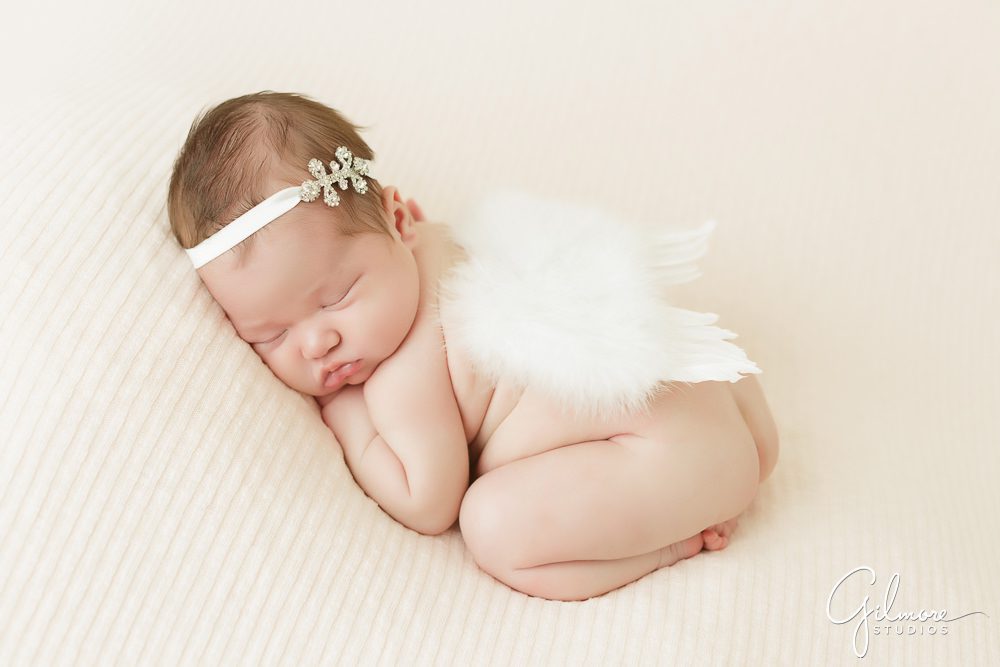 Orange County Newborn, angel wings, lace headband, flowers, bed, studio, portrait photography, sleeping, baby