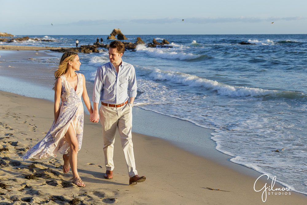 Newport Beach Engagement Session, california lifestyle, waves, ocean, rocks, sand, holding hands, engaged couple, little corona del mar, walk