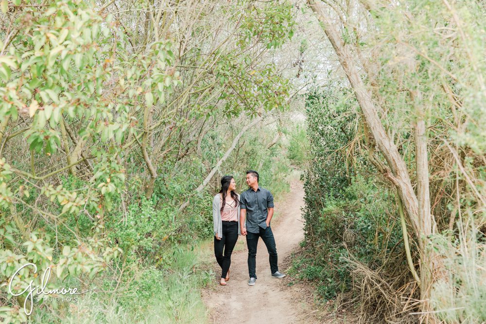 Corona Del Mar Beach Engagement Session, Newport Beach, buck gully trailhead, portrait, forest, holding hands, engaged, couple, natural light