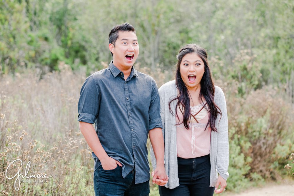 Corona Del Mar Beach Engagement Session, surprised, fun portrait, funny photo, holding hands, engaged, hiking, buck gully trailhead, hike