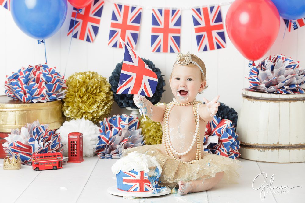 Princess London's 1st Birthday, england theme props, cake smash, flags, pom poms, balloons, messy baby portraits, studio photography, outfit, skirt, tutu, headband, necklaces, one year old, first bday, family