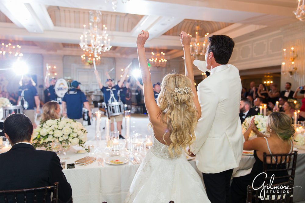 Bride and groom cheering, LA Chargers Drumline wedding, performing, Hotel Casa Del Mar, Santa Monica, CA, ballroom, reception, decor, tables