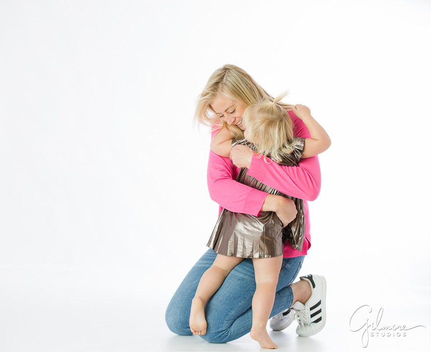 Mommy and me portrait, mom hugging 2 year old girl, daughter, kids, children, dress, pink