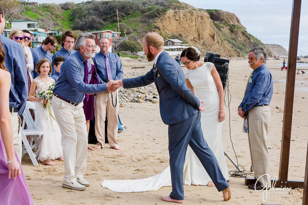 father shaking grooms hand, ceremony, beach wedding, crystal cove cottages