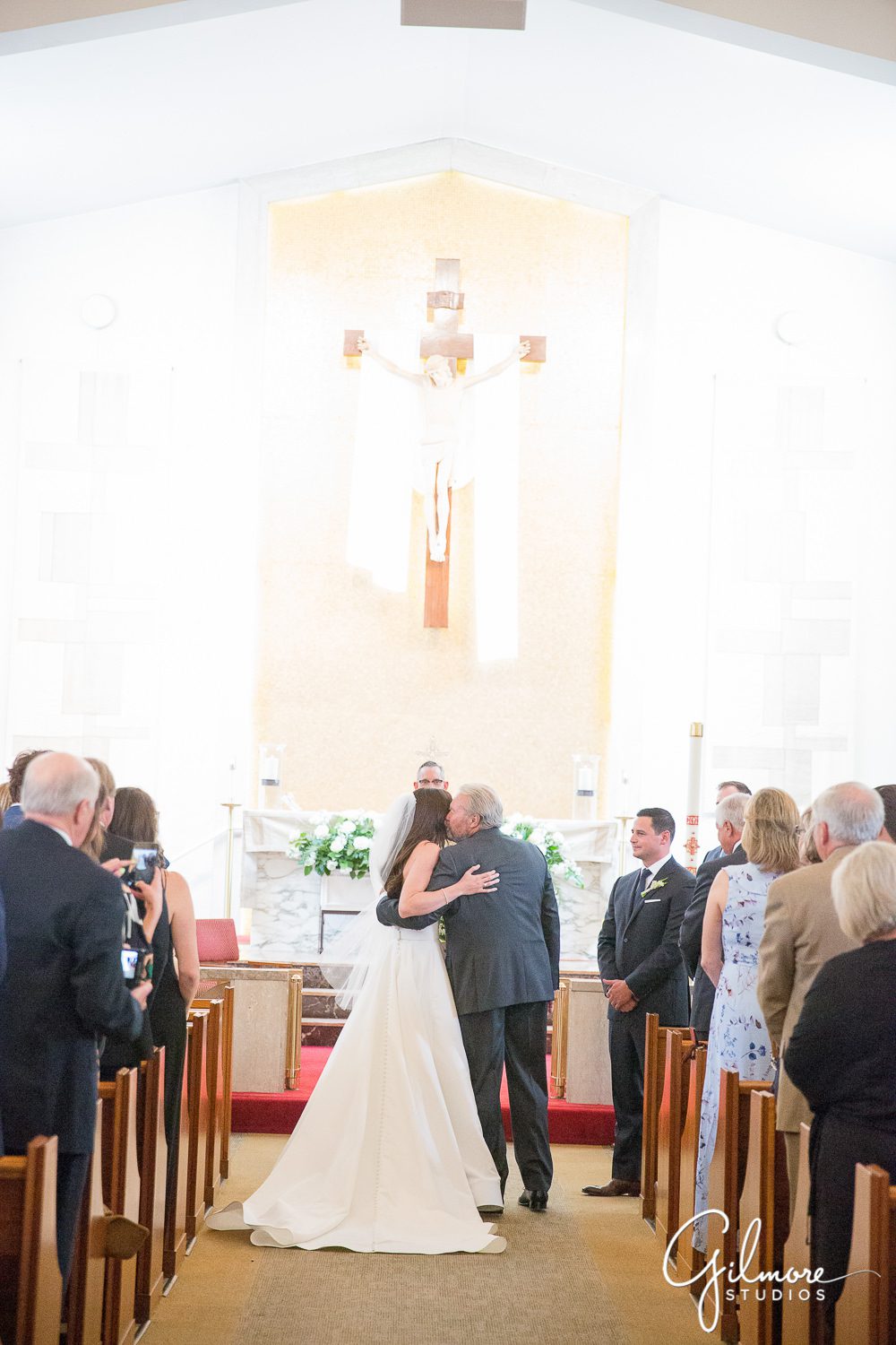 father-hugging-bride-aisle-wedding-ceremony-our-lady-mount-carmel-newport-beach-wedding-photographer