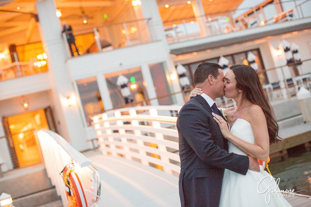 bride-groom-kiss-newport-harbor-yacht-club-wedding-reception-newport-beach-CA