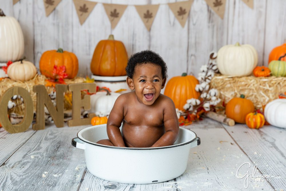 Fall themed cake smash photography session, smashcake, background, one year old, bath tub, little boy, Halloween