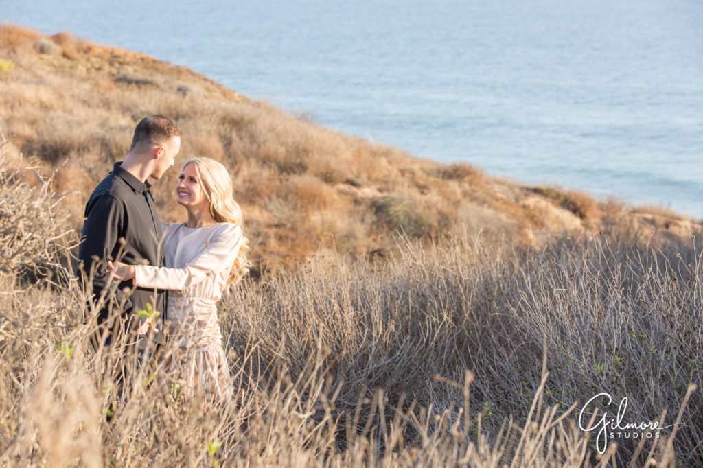 Crystal Cove Engagement Photography Session, Newport Beach, cute short dress, outfit, outfits, skirt, Orange County wedding photographers, Gilmore Studios, ocean view, coast, beach, trail, sun
