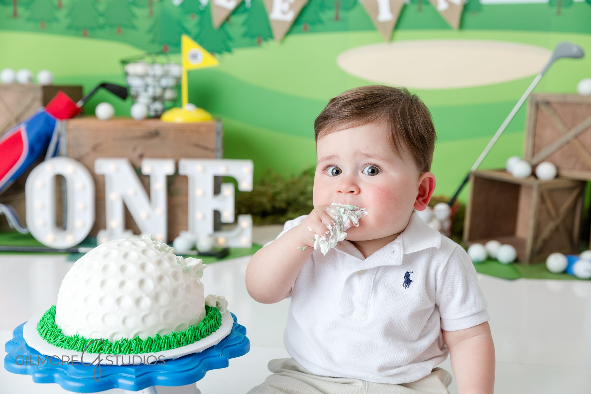 baby boy eating cake, golf cake smash, hole in 1, golfing theme, one year old, first birthday, golf ball cake, golfing set, design, decor, photographer