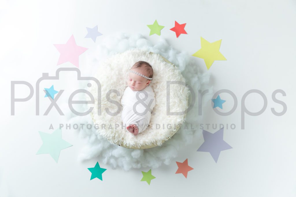 Newborn Digital Backdrops styled by Pixels and Drops with puffy white clouds and colorful paper stars on a white background with white faux fur