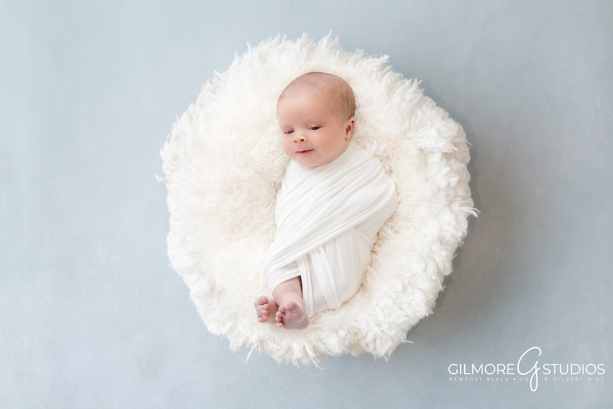 Gilbert Newborn Photographer, family portrait with baby, baby studio in Gilbert, AZ - Chandler, Queen Creek, Scottsdale, Professional Newborn Photography Studio, family session with toddler and newborn baby boy. blue background, baby bowl prop, clean and simple, it's a boy