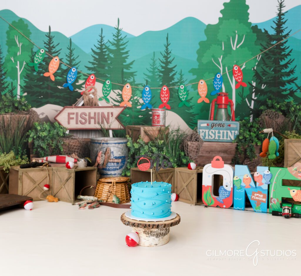 gilbert cake smash photography studio, 1st birthday, east valley kids photography studio, gone fishin' first birthday photo session, fishing theme, one year old, cakes for boys birthday party, blue cake, bobbers, fishing pole, cute forest camping theme for boys