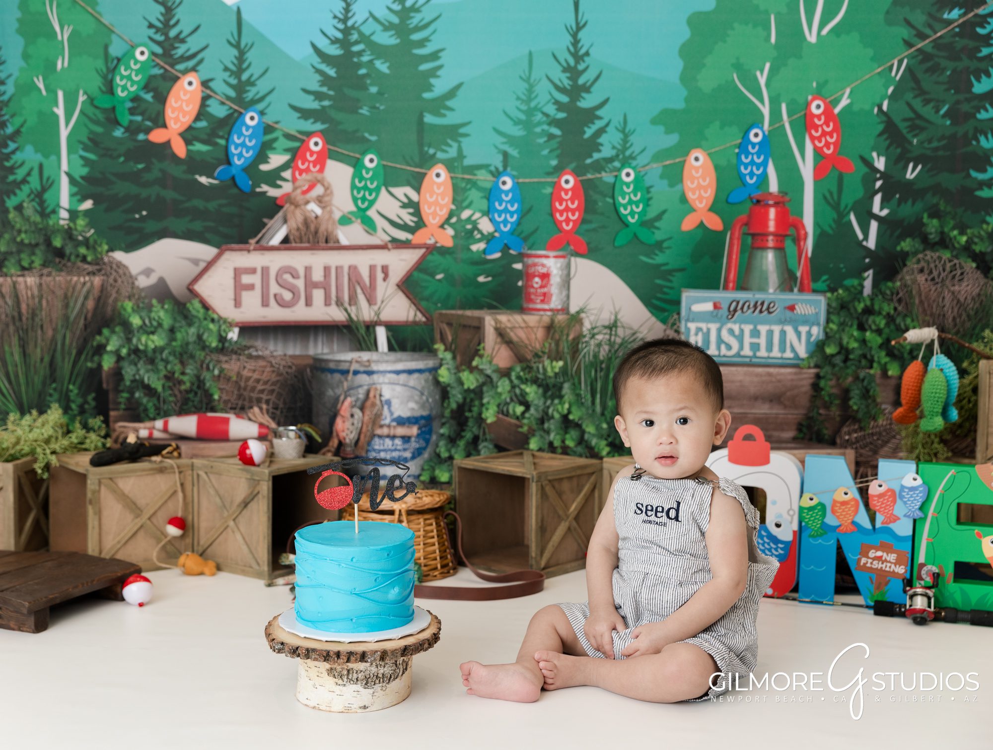gilbert cake smash photography studio, 1st birthday, east valley kids photographer studio, gone fishin' first birthday photo session, fishing theme, one year old, cakes for boys birthday party, blue cake, bobbers, fishing pole, cute forest camping theme for boys