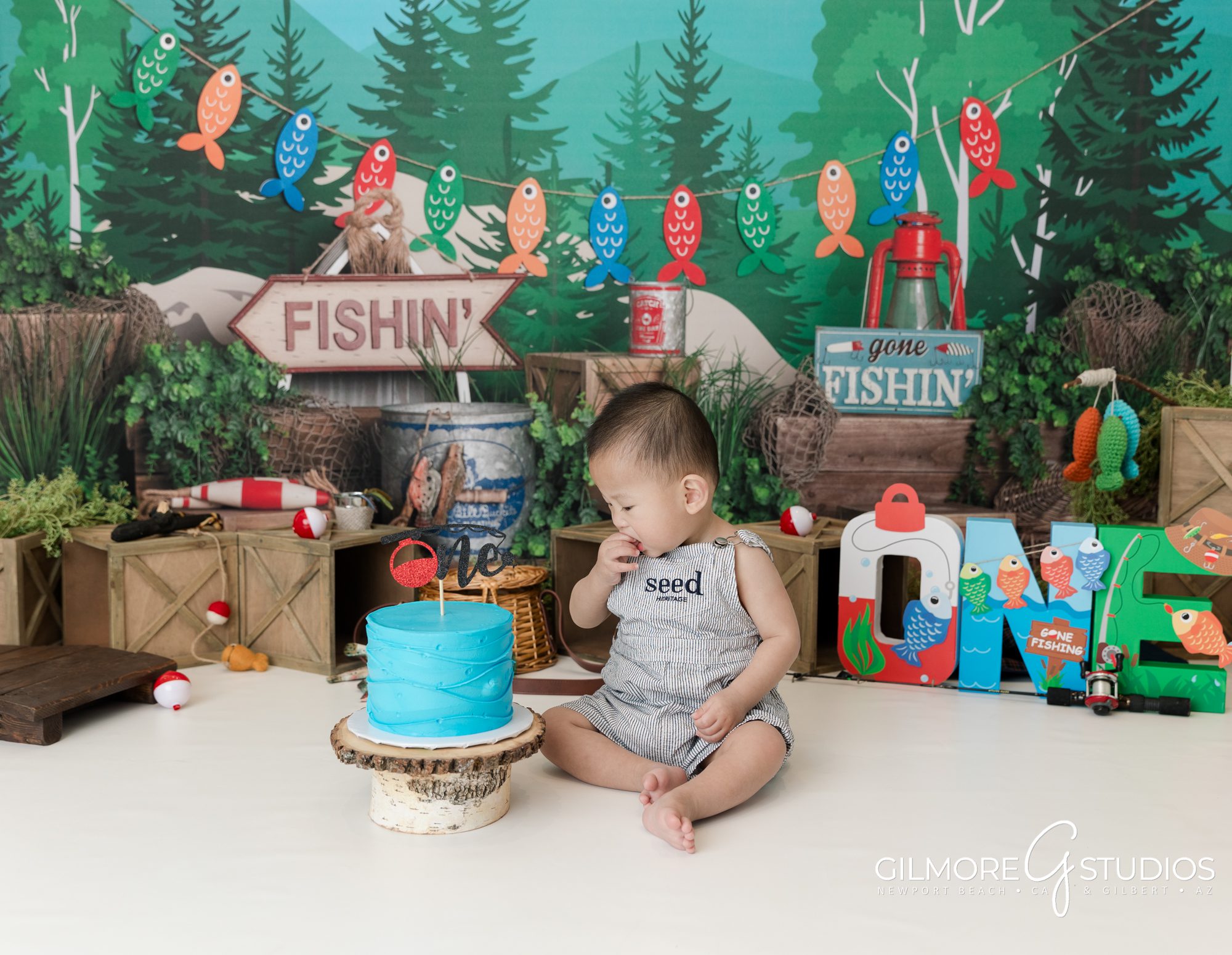 gilbert cake smash photographer, 1st birthday, east valley kids photography studio, gone fishin' first birthday photo session, fishing theme, one year old, cakes for boys birthday party, blue cake, bobbers, fishing pole, cute forest camping theme for boys