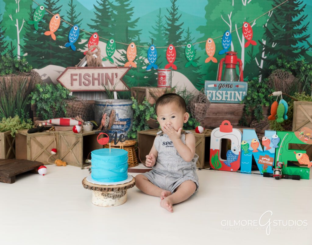 gilbert cake smash photography studio, 1st birthday, east valley kids photographer, gone fishin' first birthday photo session, fishing theme, one year old, cakes for boys birthday party, blue cake, bobbers, fishing pole, cute forest camping theme for boys