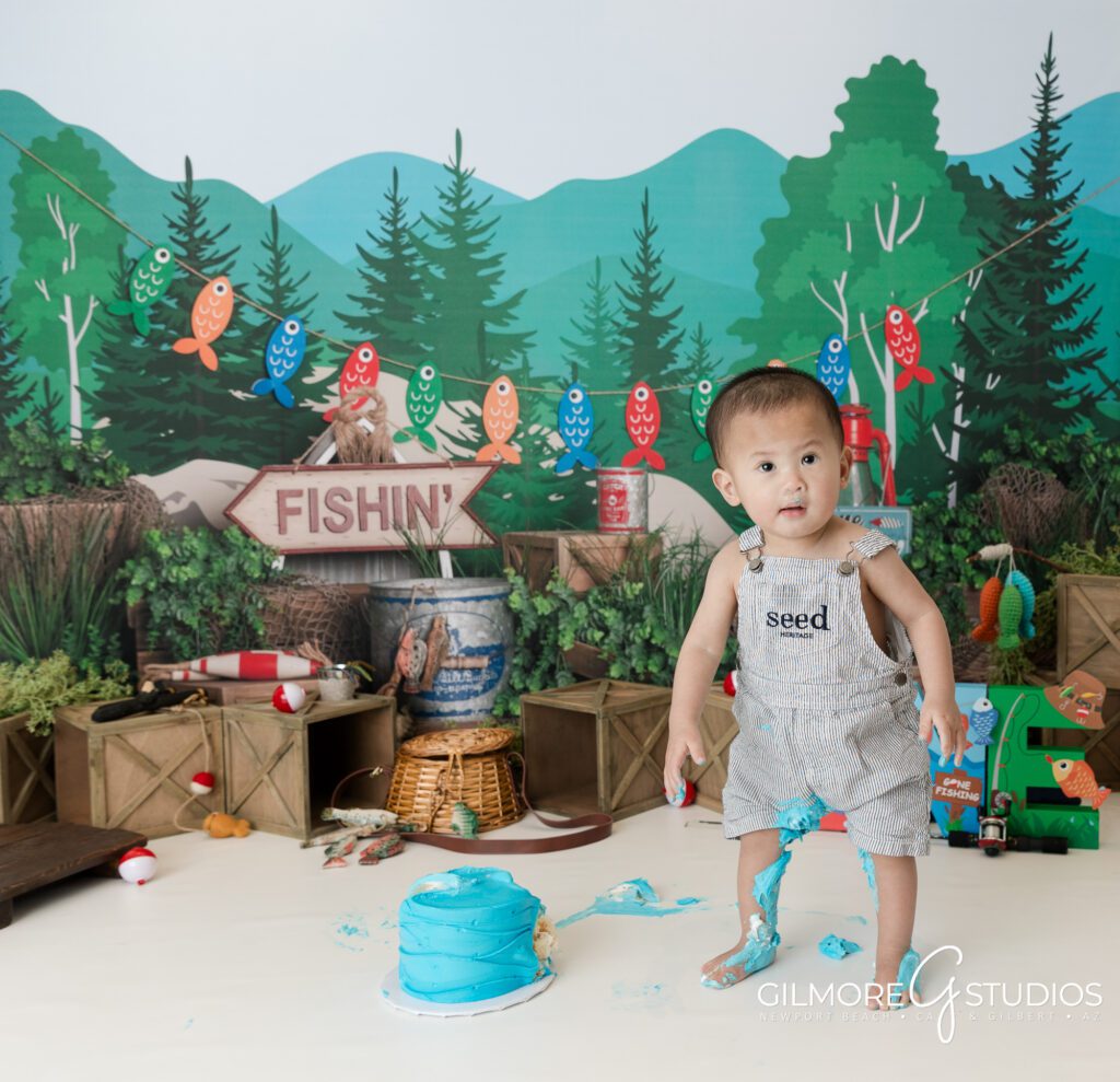 gilbert cake smash photography studio, 1st birthday, east valley kids photographer, gone fishin' first birthday photo session, fishing theme, one year old, cakes for boys birthday party, blue cake, bobbers, fishing pole, cute forest camping theme for boys