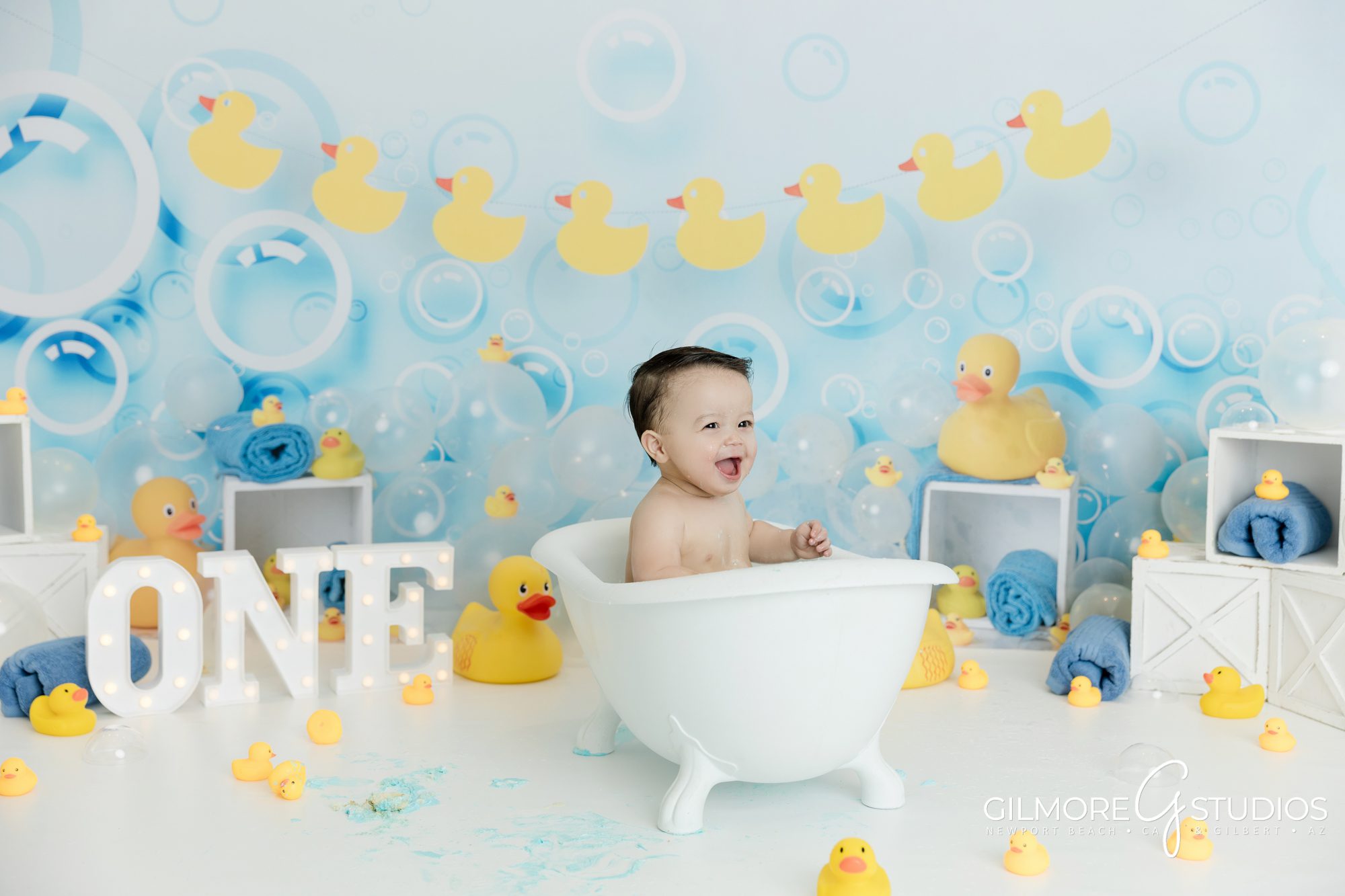 Rubber Ducky Cake Smash Photography Session, Gilbert Children's Photographer, Queen Creek Baby Photo Studio, Gilmore Studios, Yellow rubber ducky, bath, bubbles, set design, props, baby outfit, 1 year old, one year old boy, cake, bowtie, photo