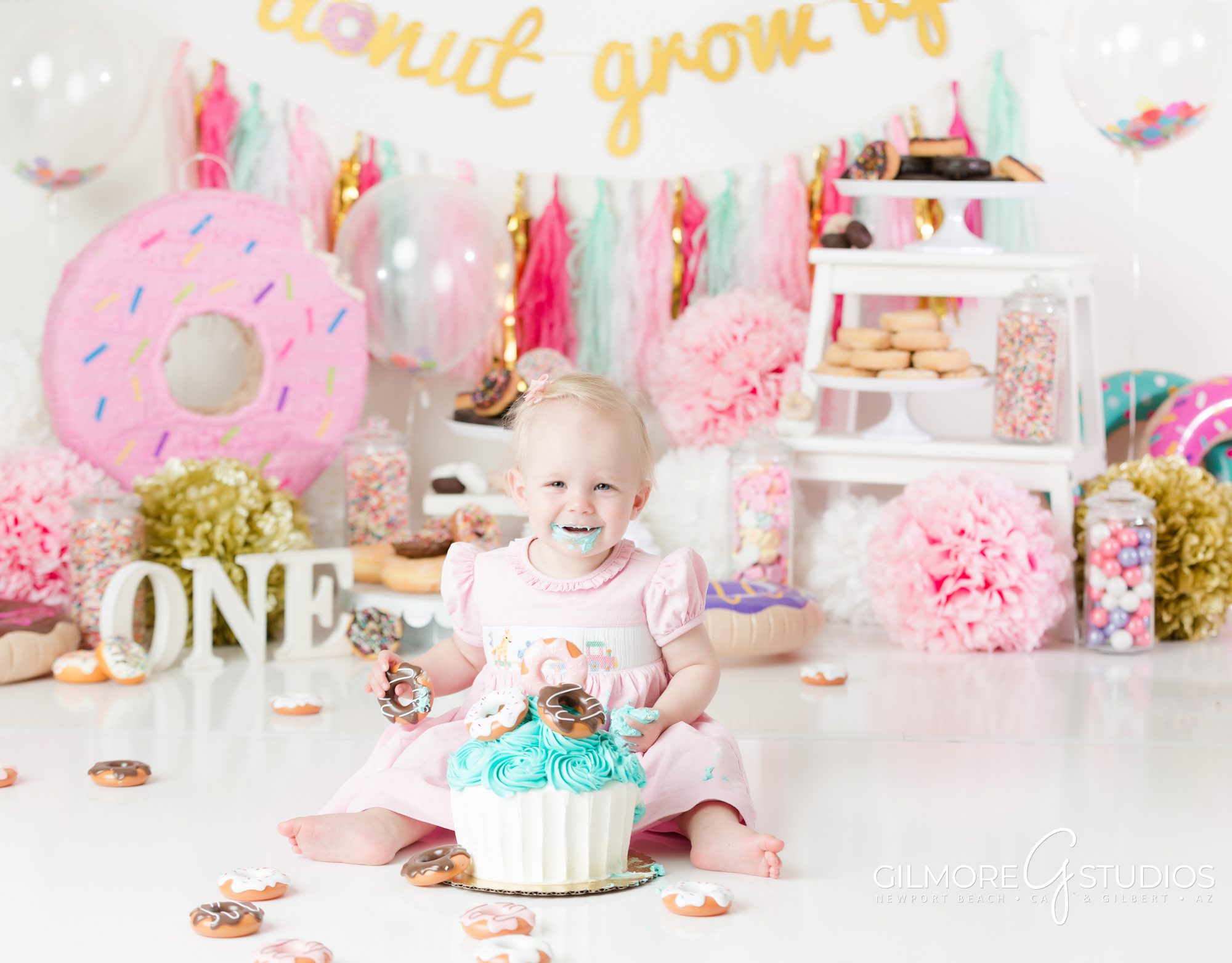 donut grow up cake smash theme, gilbert AZ, photography studio, doughnut, donuts, sweets, custom cake, Gilmore Studios, pink, white, teal, studio photo session for one year old birthday, 1st birthday
