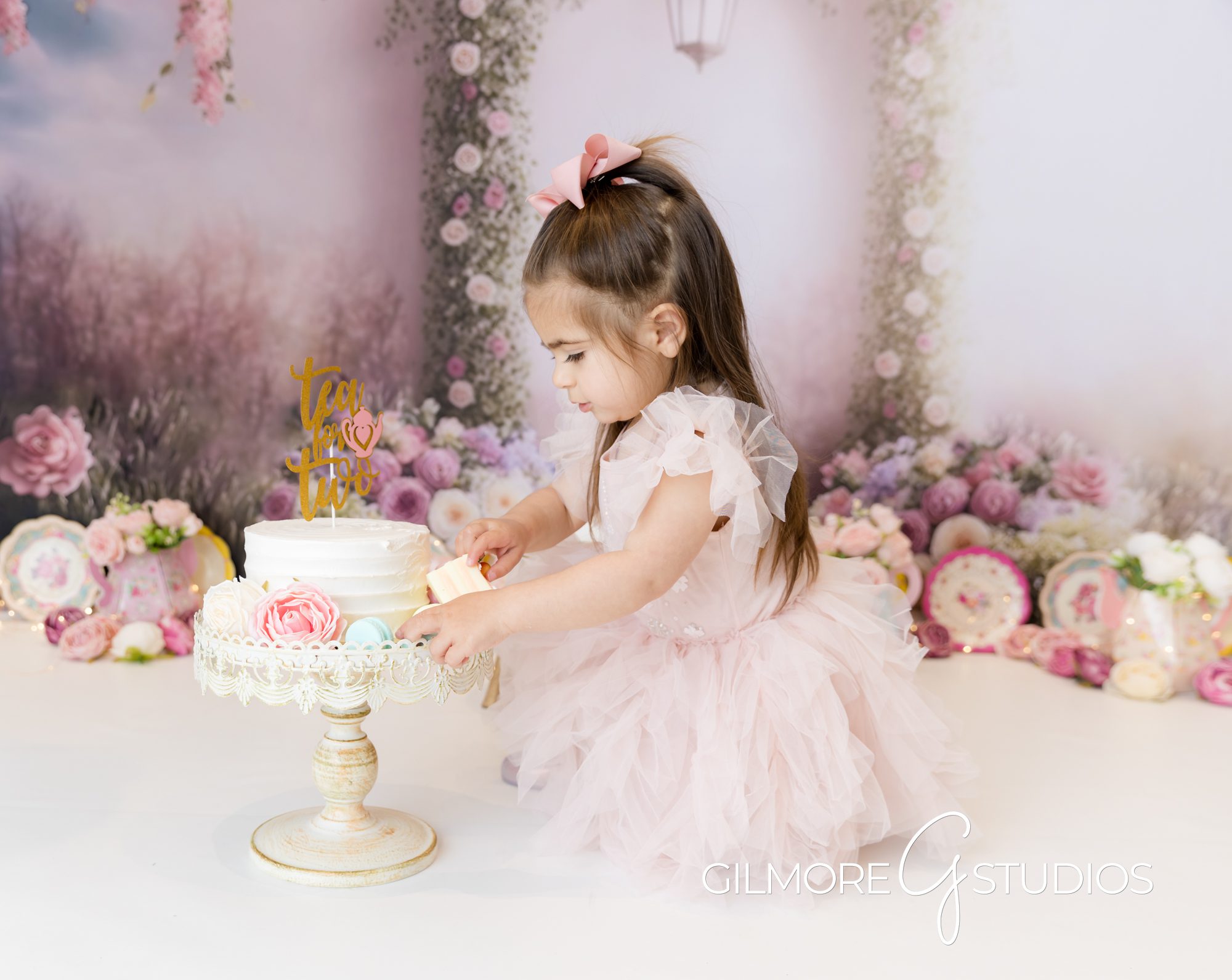 tea party cake smash, white cake, little girl, pink bows, pink dress, little girl eating cake, gilmore studios