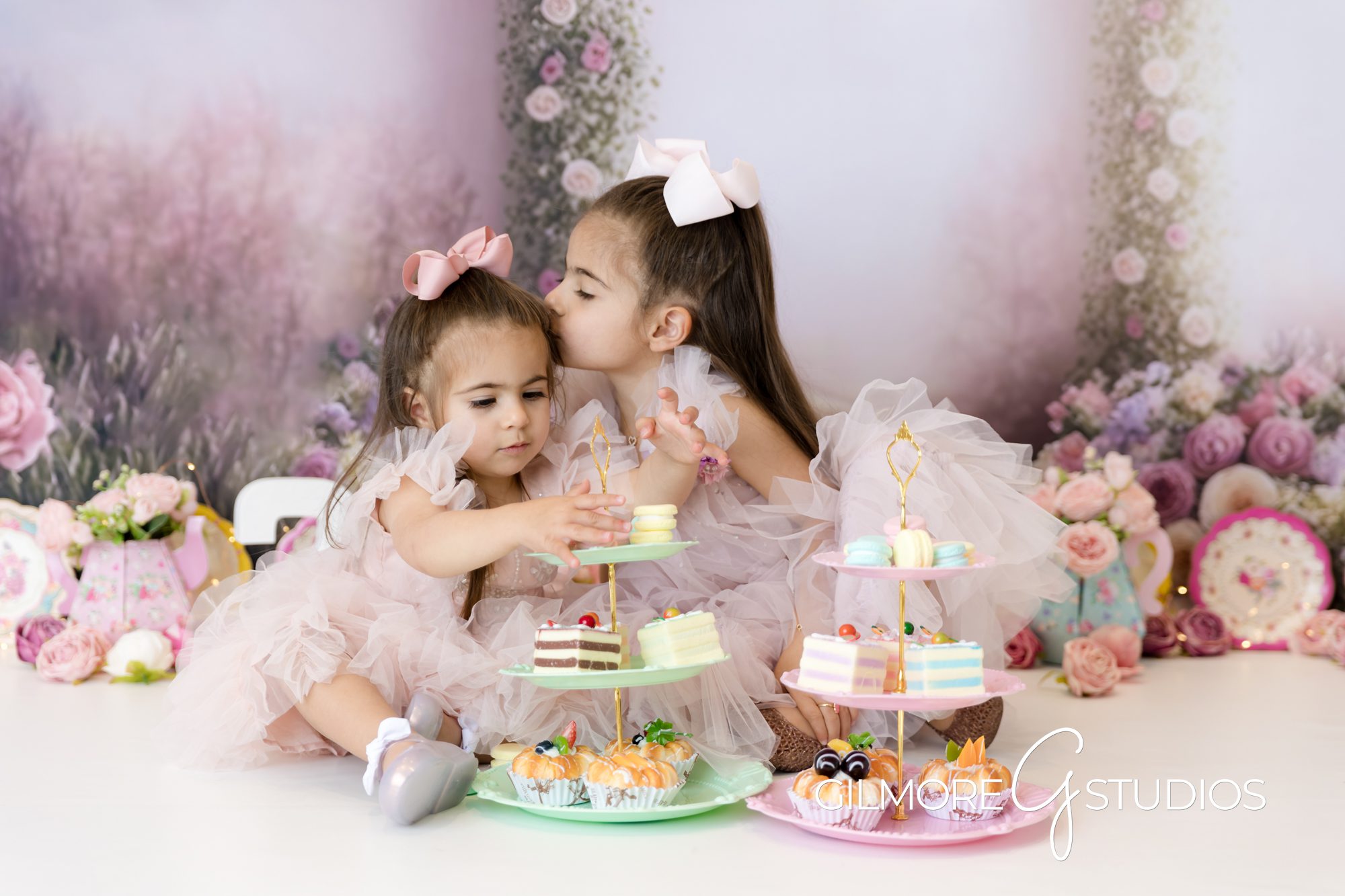 tea party cake smash, little sister, big sister, pink dresses, tea cakes, sweets, macaroons, pink bows, gilmore studios
