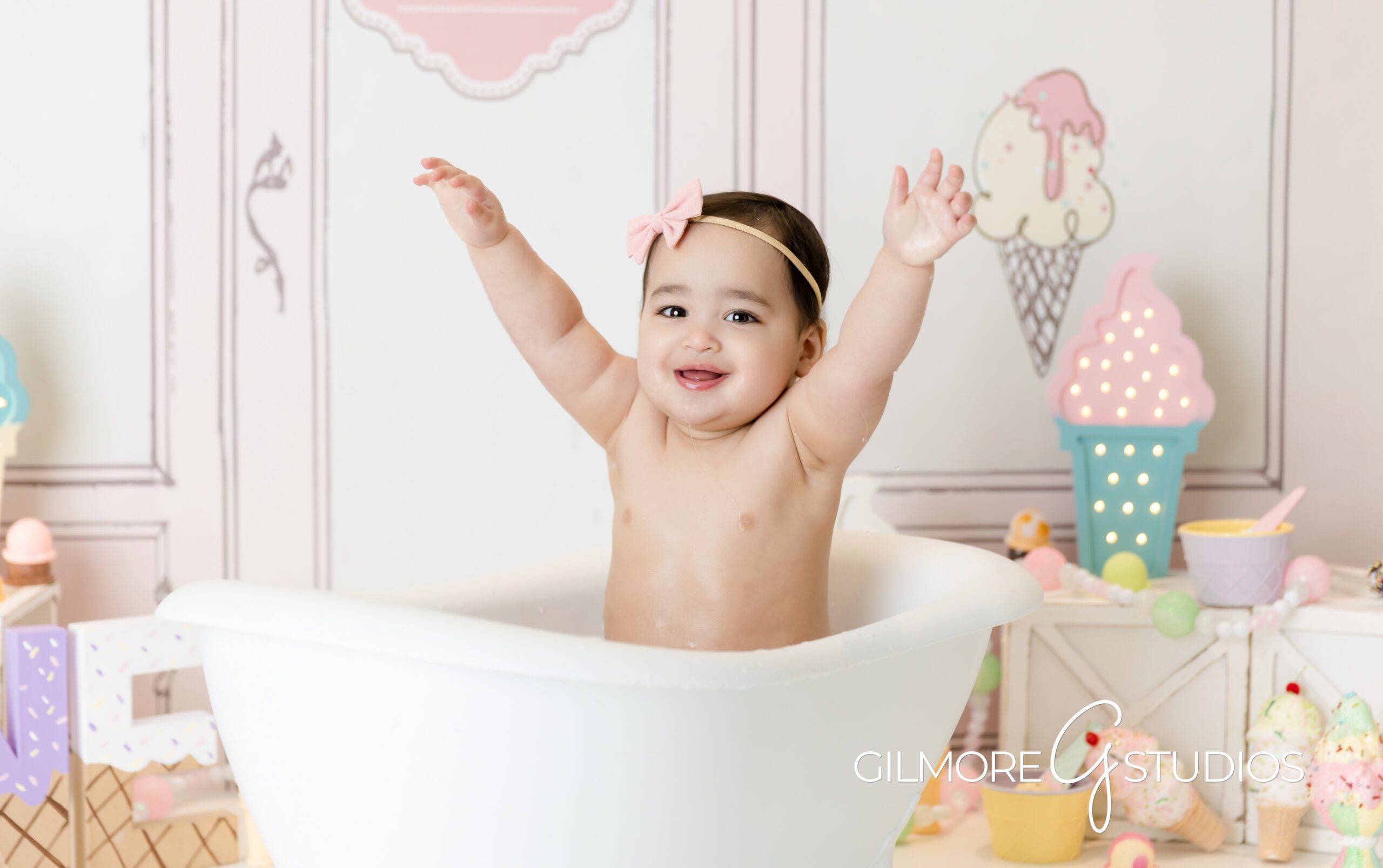 ice cream theme cake Smash, little girl, little girl with arms up, bathtub, smiling, photography, Gilmore Studios