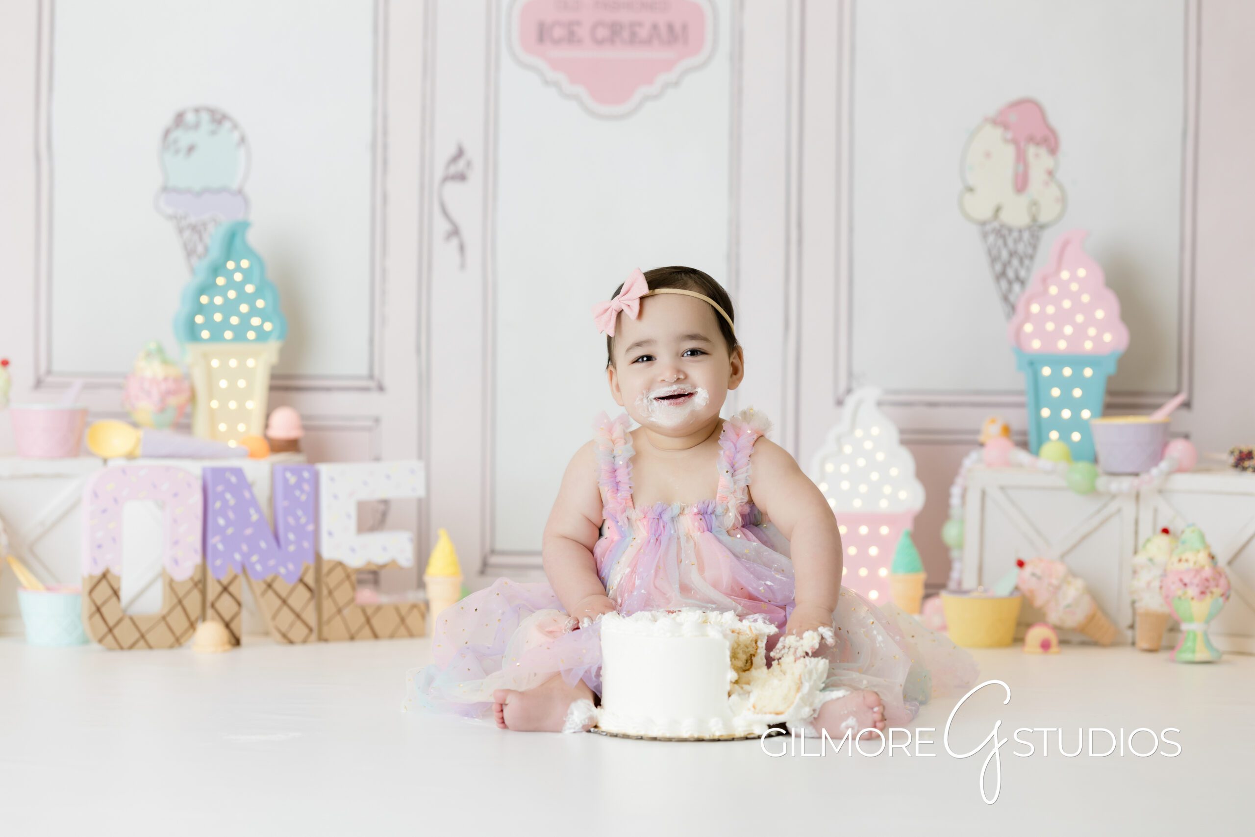 ice cream theme cake Smash, little girl, white cake, ice cream theme, ice cream parlor, pink dress, eating cake, Gilmore Studios