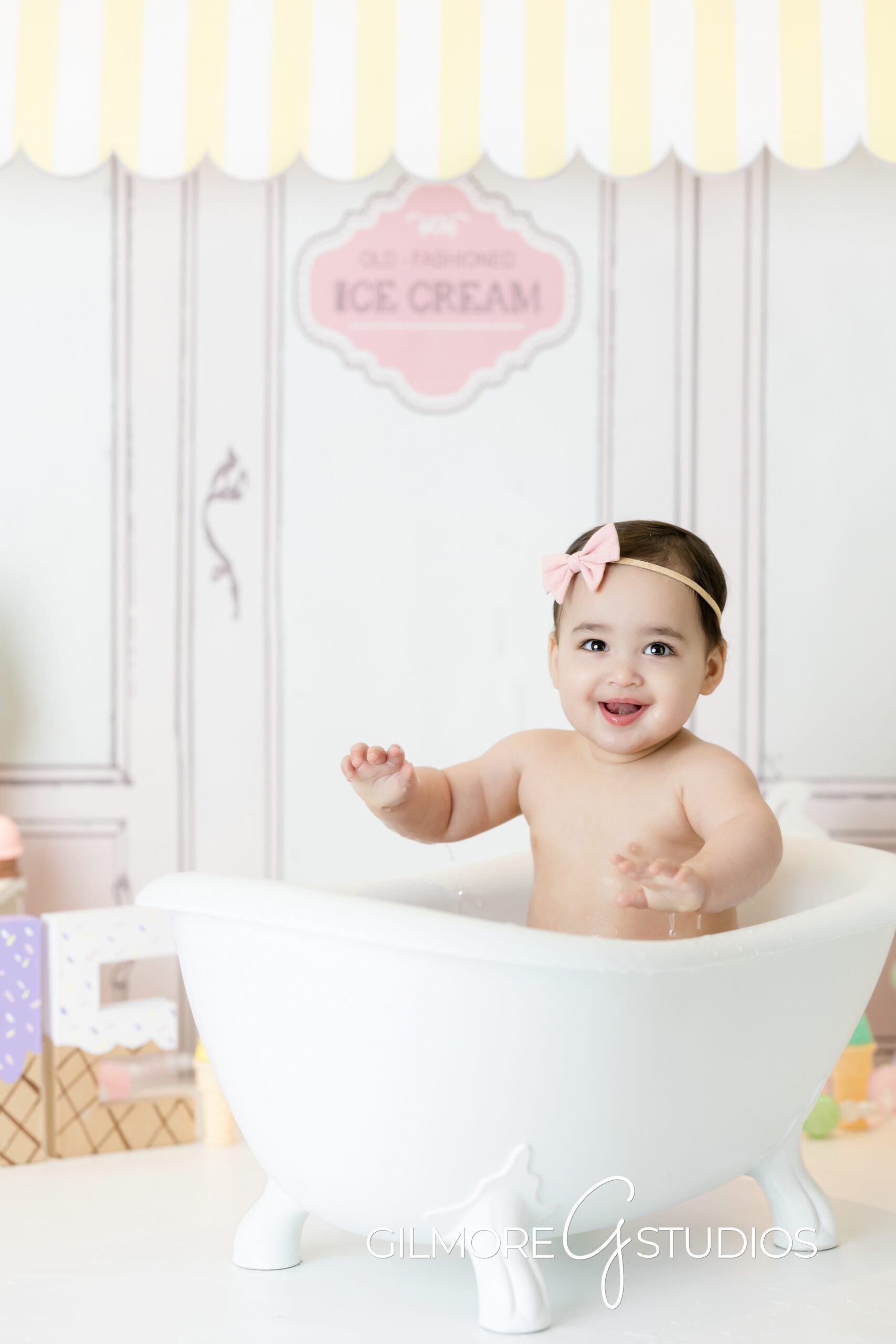 ice cream theme cake Smash, little girl, bathtub, pink bow, smiling, photography, Gilmore Studios
