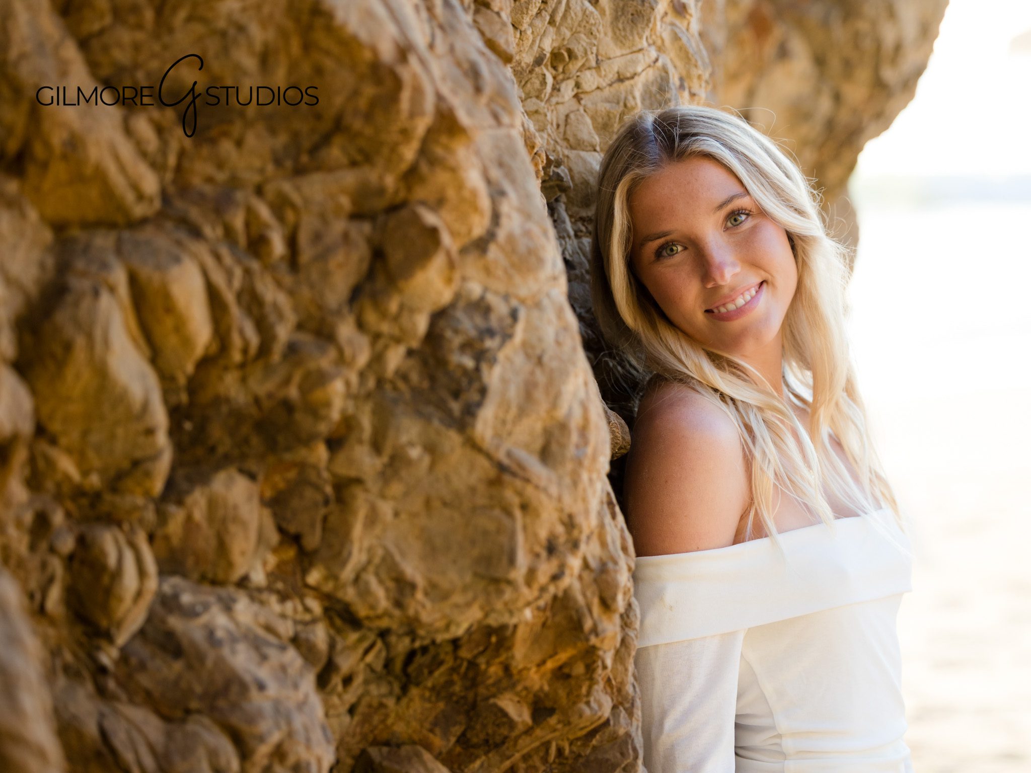 Laguna Beach high school senior photos, ocean waves, rocks, sunset backdrop