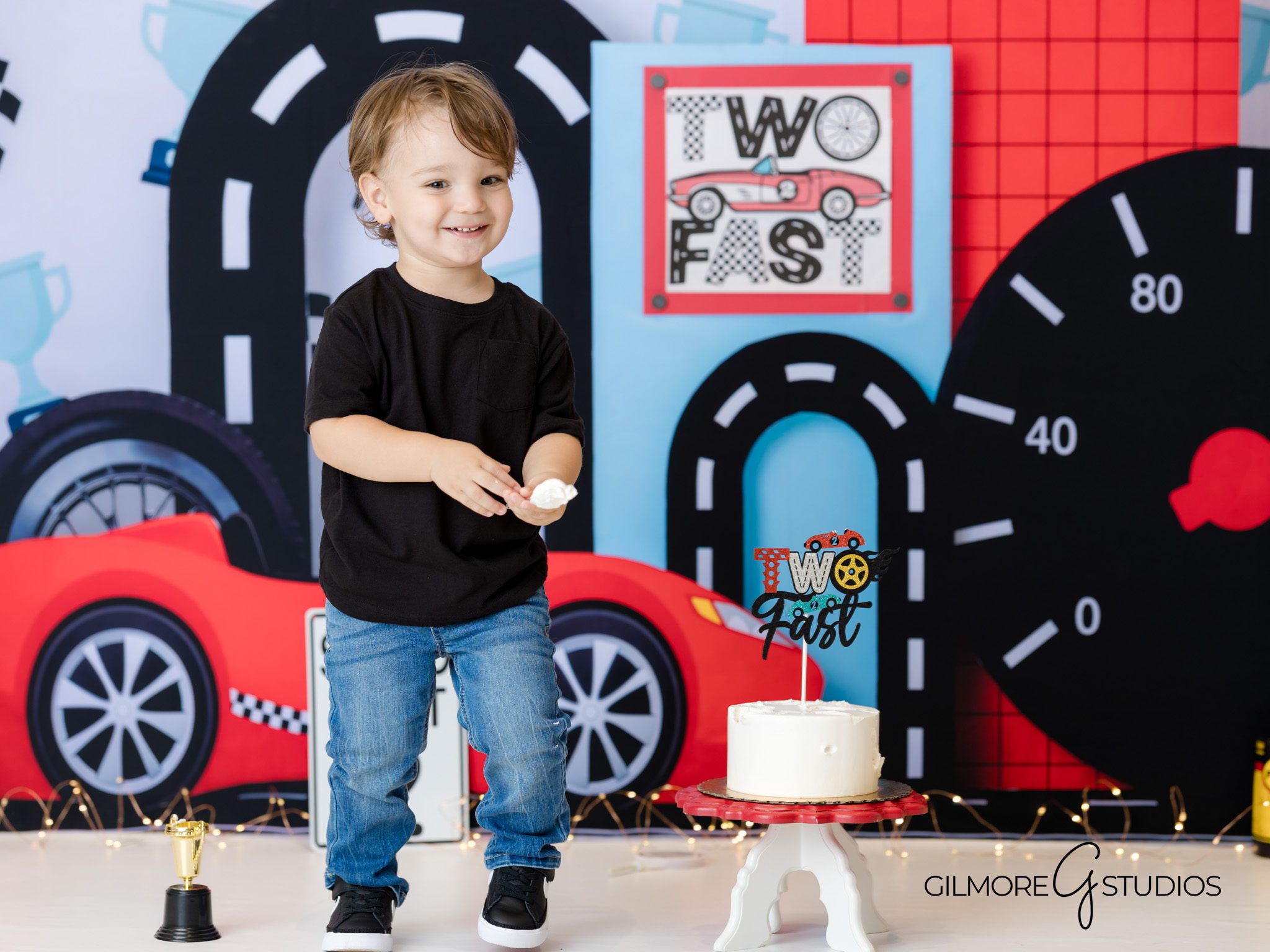 Race track birthday setup, two-year-old milestone photos, car theme toddler photography