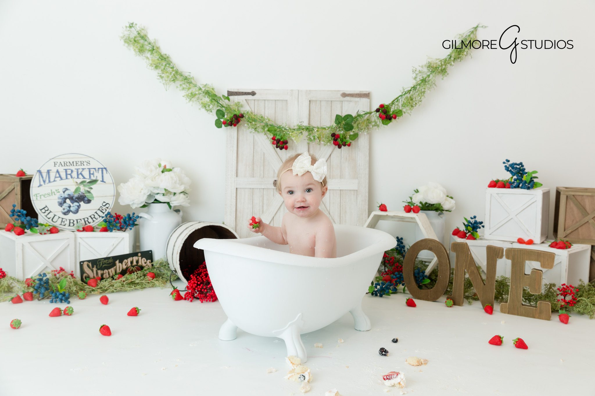 Baby with berry frosting – cake smash session – soft pinks and reds