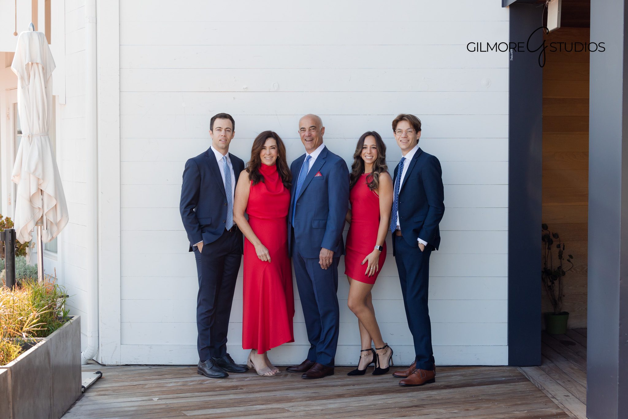 Family smiling together on a dock at Lido Island