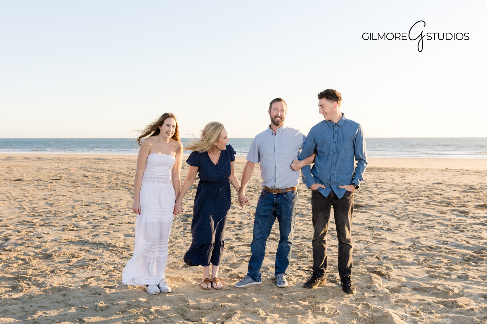 Sunset family photo with wooden pier in the background
