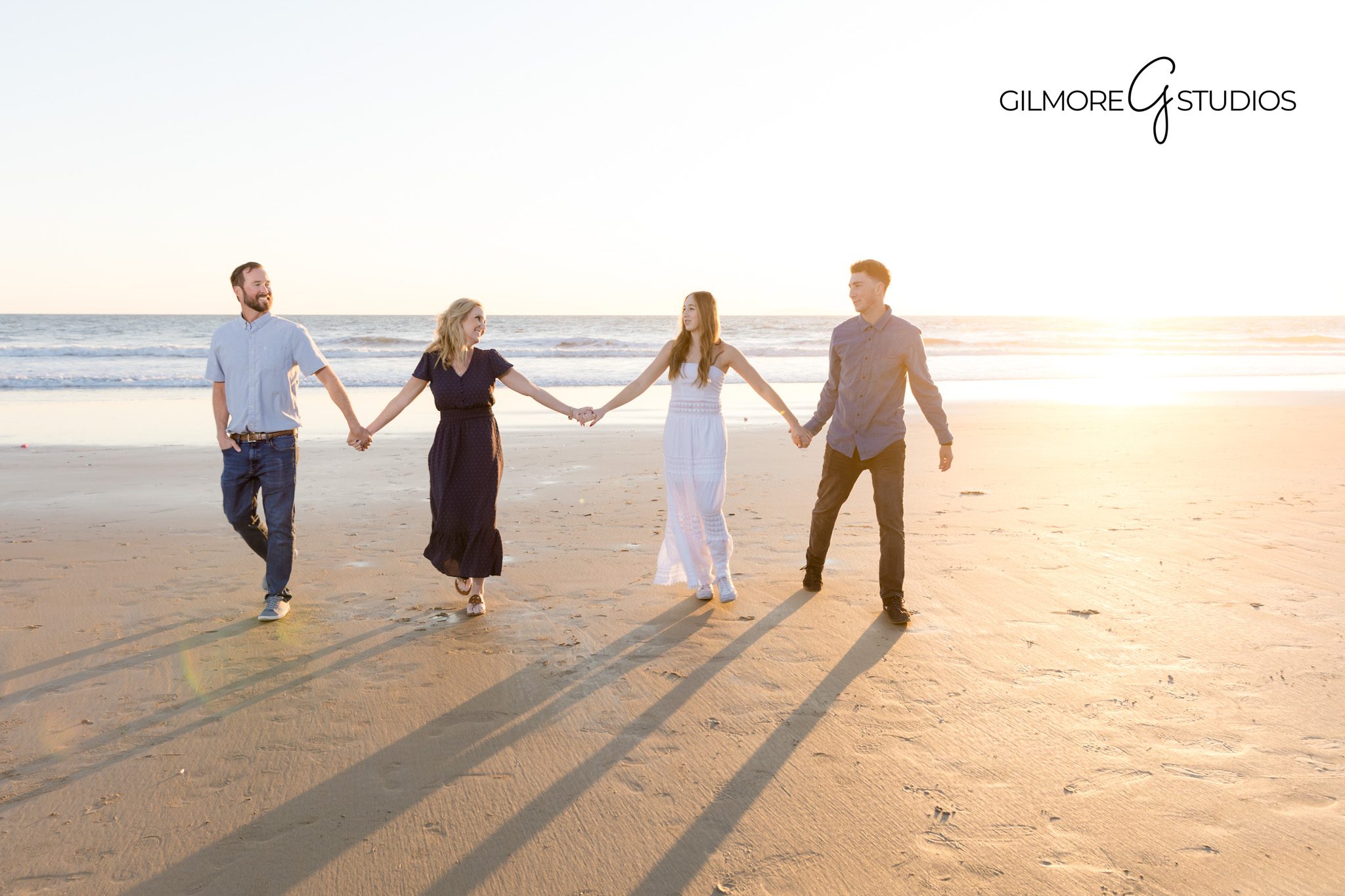 Siblings walking hand-in-hand on the beach