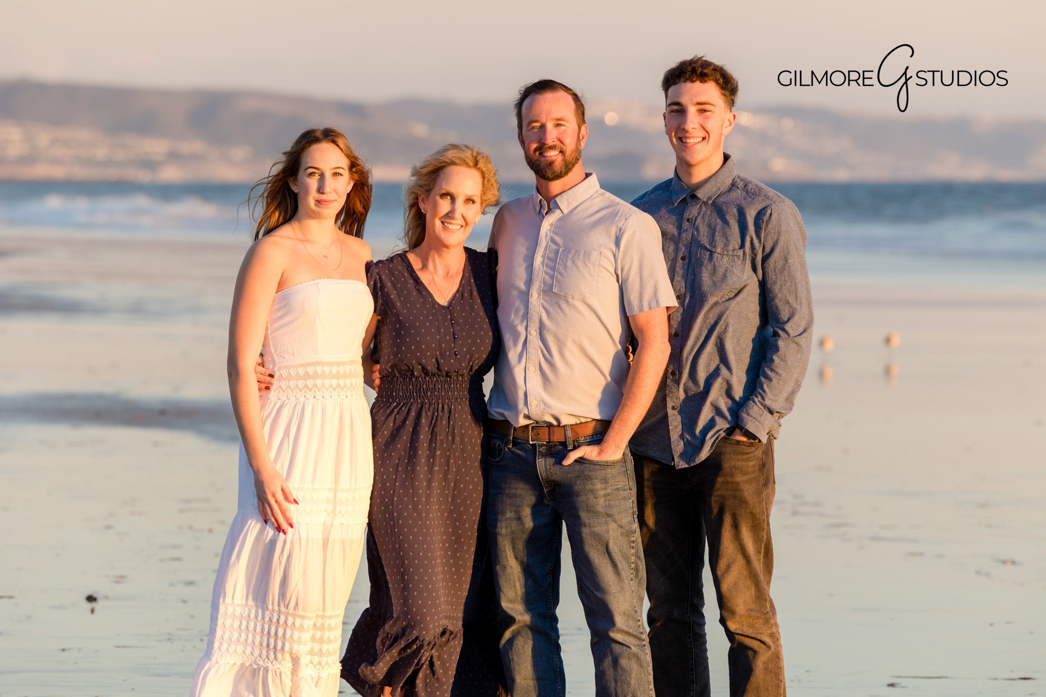 Coastal breeze family hug on the beach
