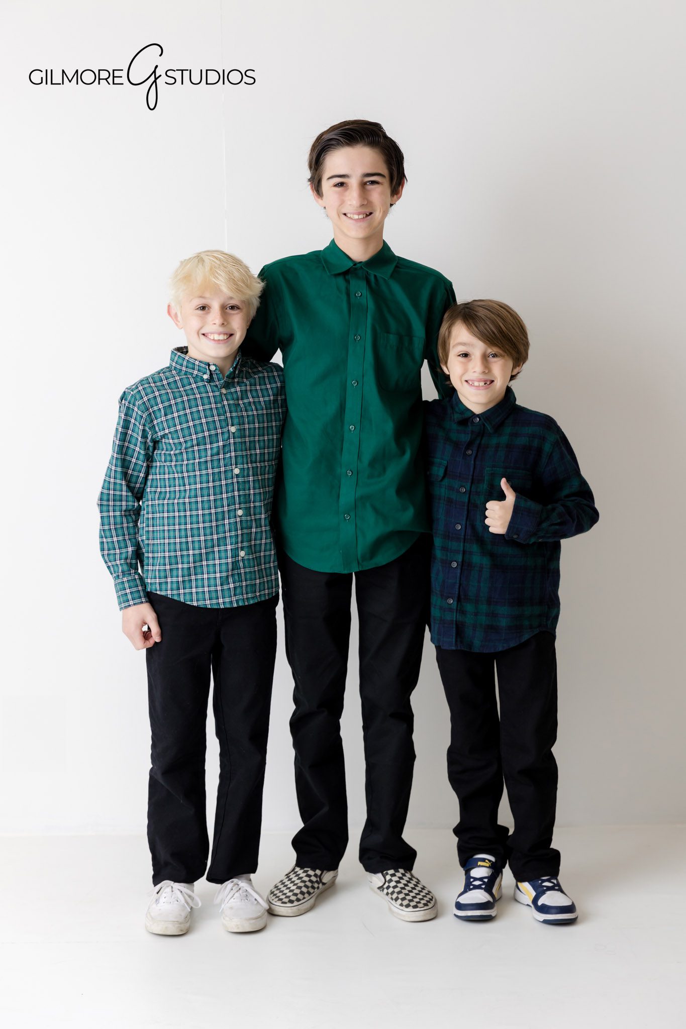 professional family photo Newport Beach, coordinated outfit ideas, studio backdrop portrait, toddler and parents in photo session