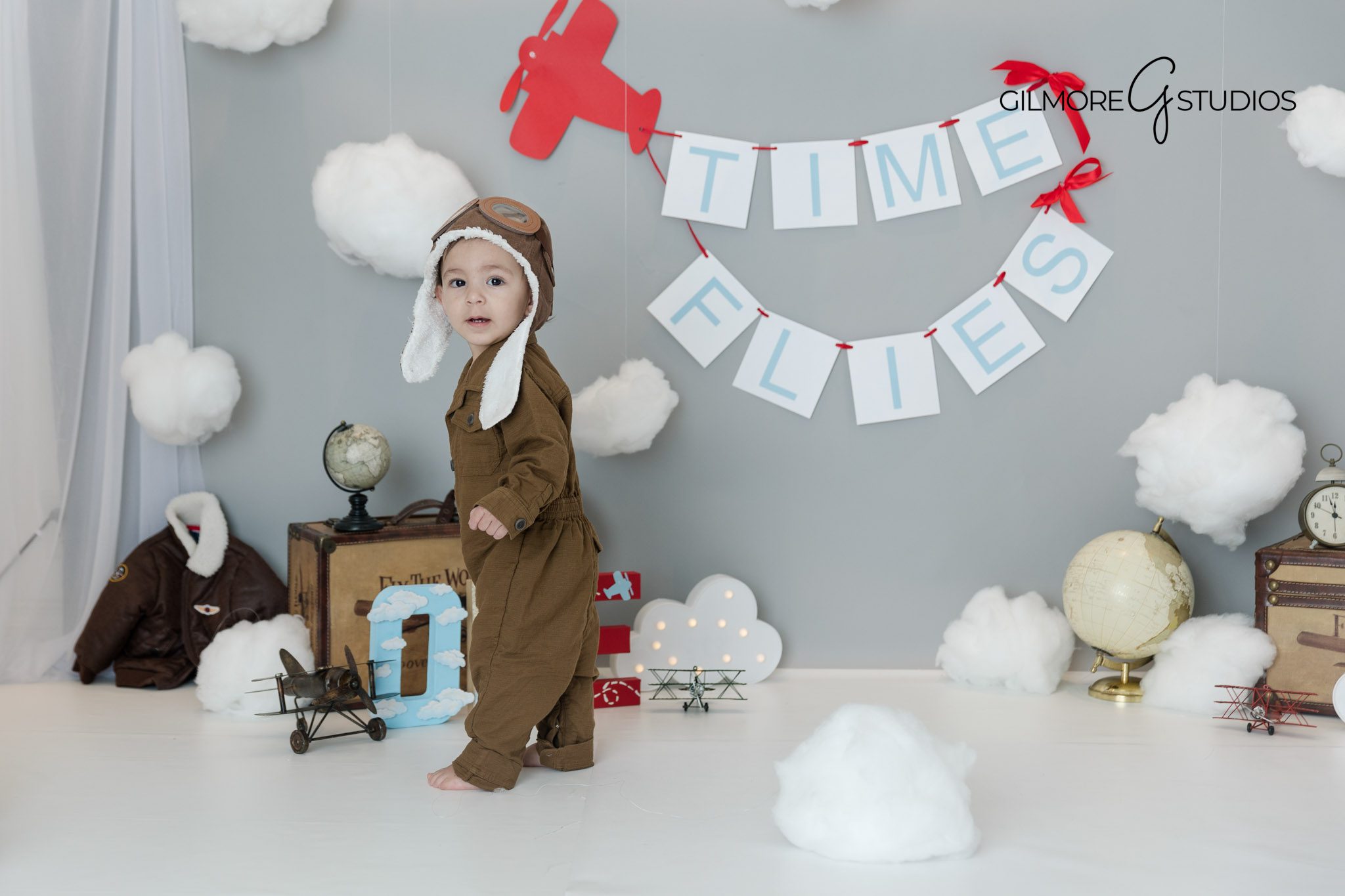 Grey Time Flies birthday theme baby boy cake smash photography Gilbert Arizona studio, Gilbert AZ photographer first birthday cake smash portraits in grey and blue airplane theme