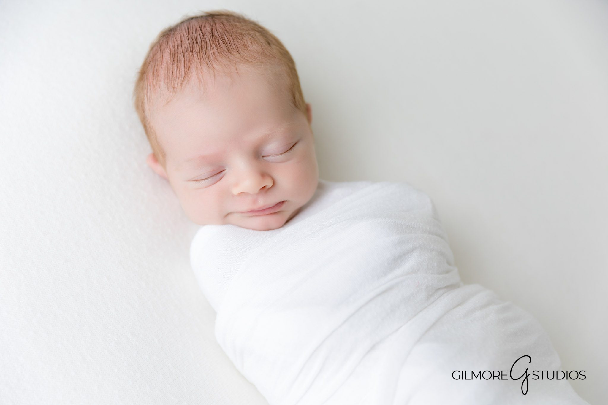sleepy newborn photo in Newport Coast white studio, cozy baby portrait by Newport Coast newborn photographer