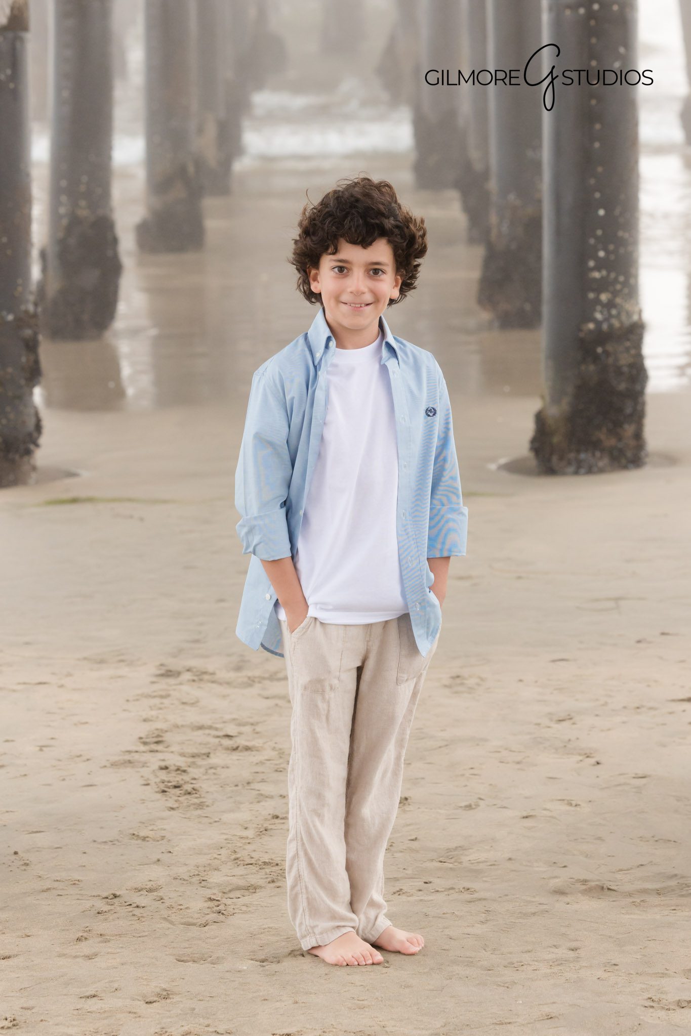 Artistic beach portrait of child in Newport fog, Moody family photography on a foggy pier