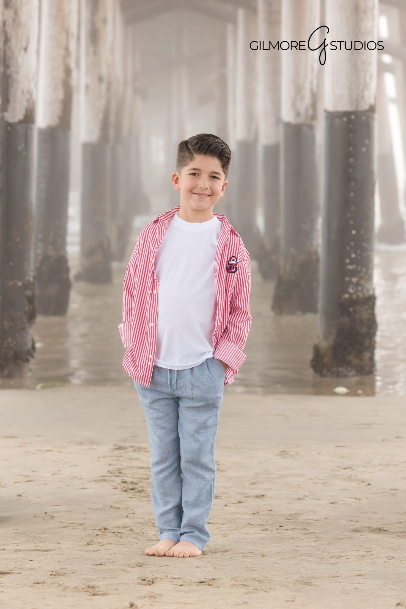 Child wearing neutral outfit at misty beach, Children playing in sand near Newport Pier
