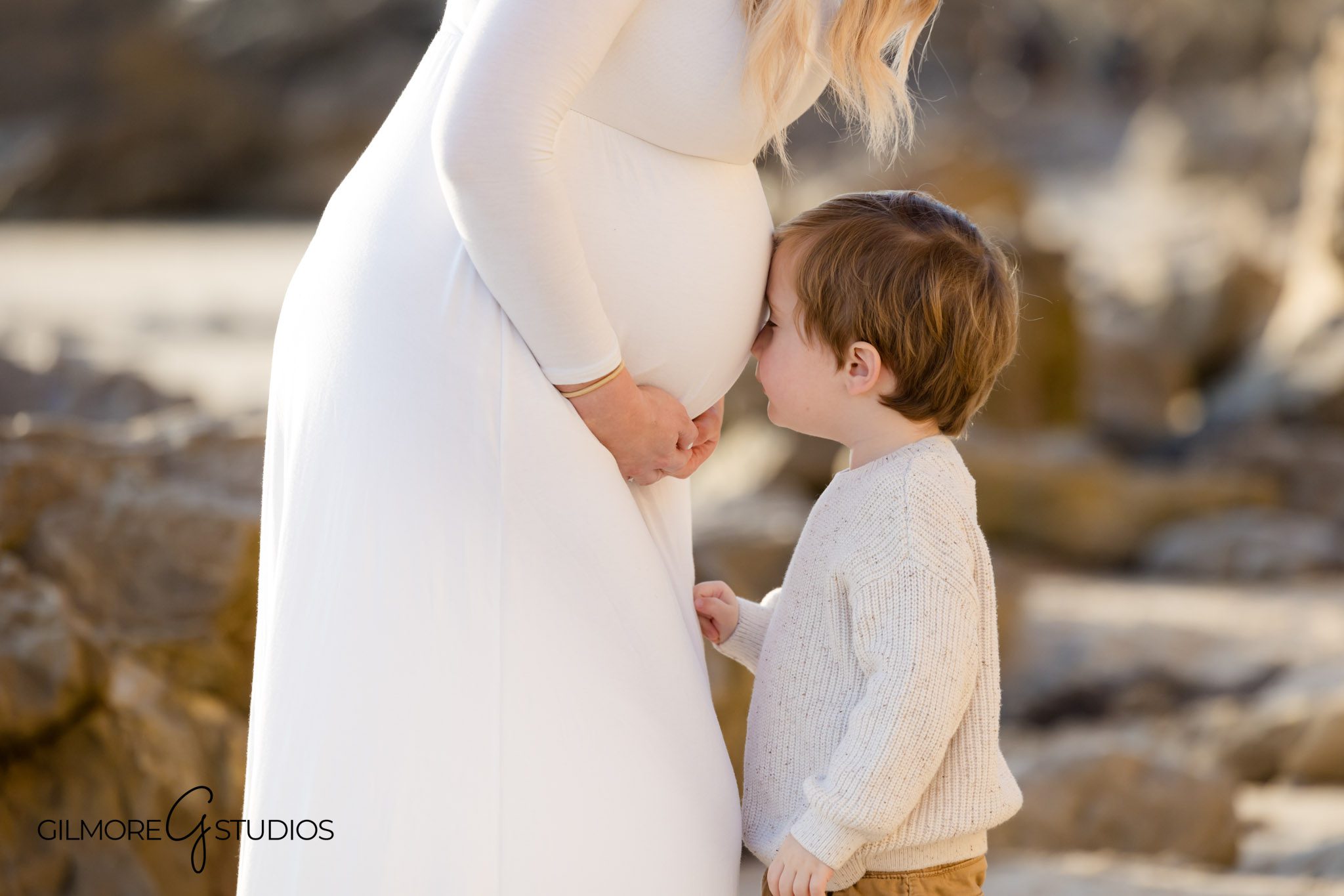 Professional beach maternity portraits in Newport Beach, Baby bump beach photography in flowing dress