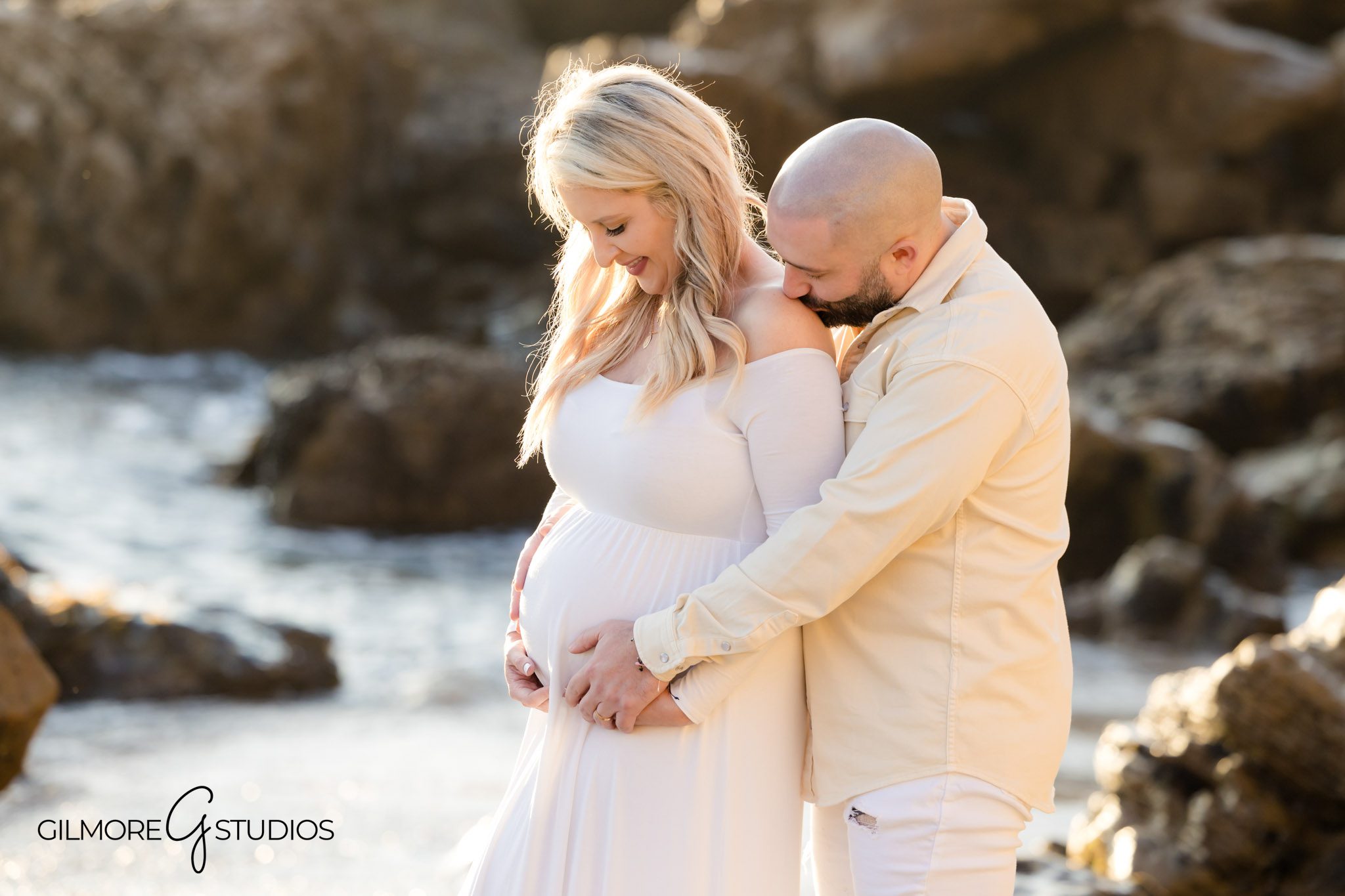 Beachside pregnancy photography with rocks and waves, Orange County beach maternity photographer session