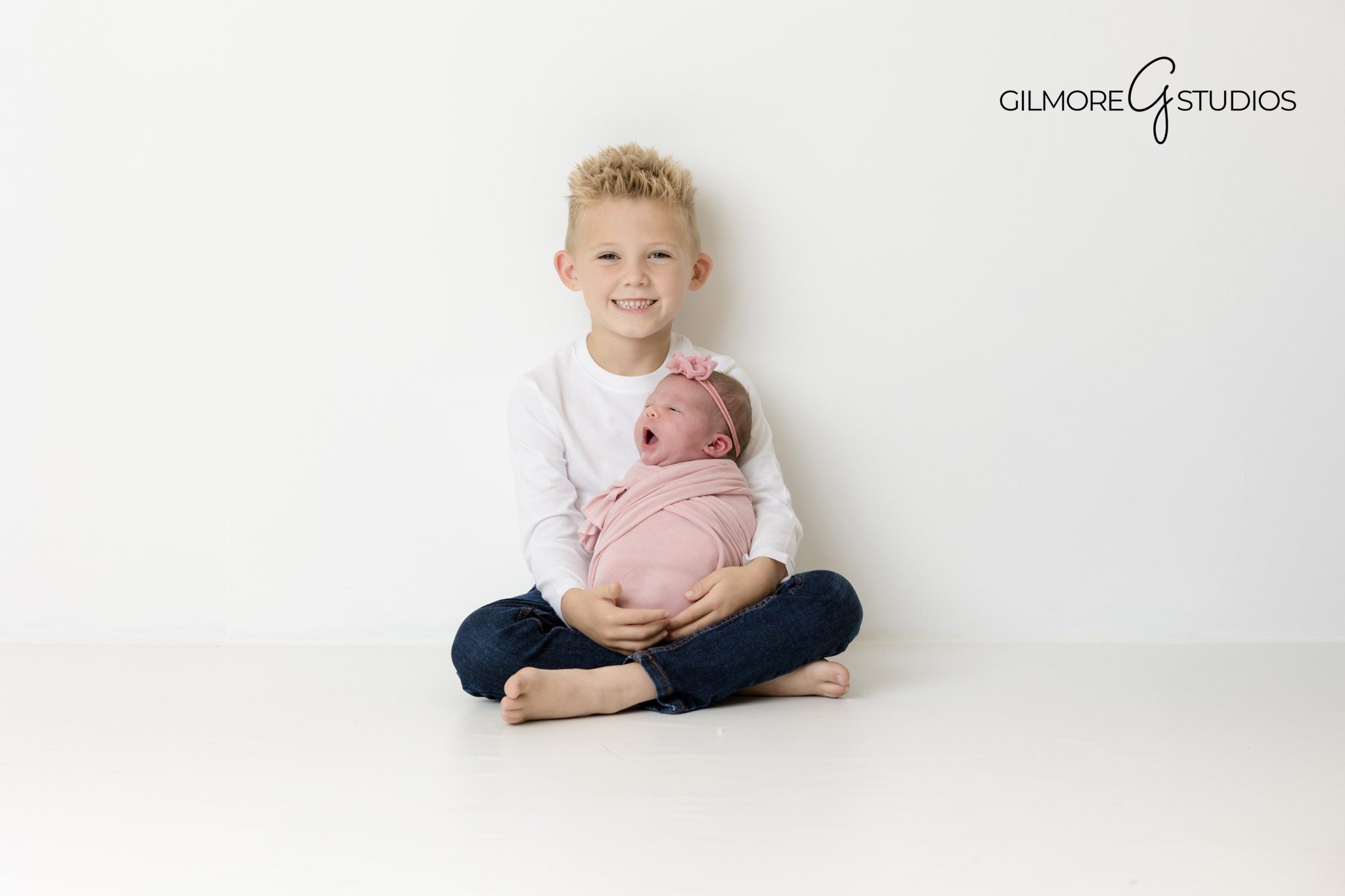 photography inspiration for newborn sessions, Newport Beach baby boy photographer, soft baby portrait in studio basket, baby curled up in wrap pose