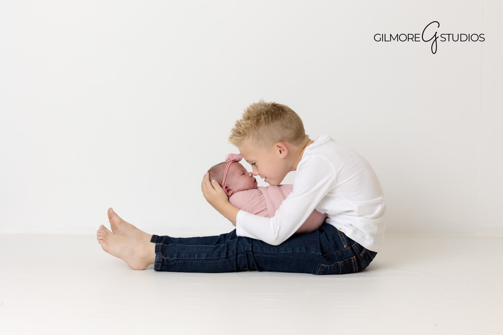 professional baby photographer Newport Coast, natural light baby session Newport Beach, soft setup for newborn photos, baby wrapped in swaddle image