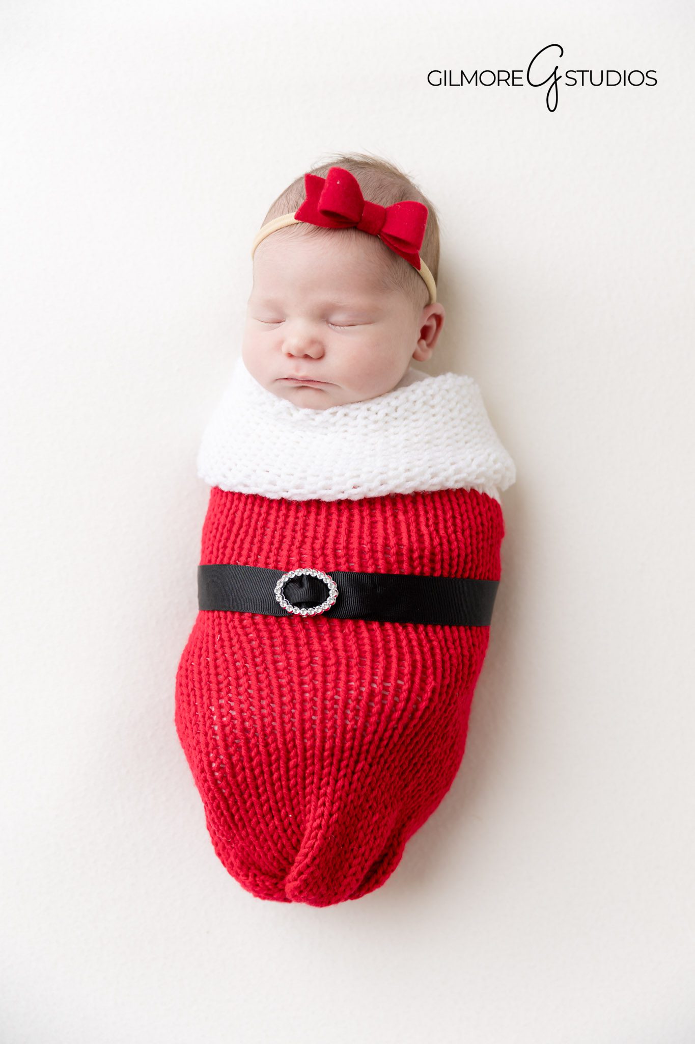 baby swaddled and sleeping photo idea, top Orange County newborn photographer, Newport baby photo shoot setup, baby girl studio pose with soft lighting