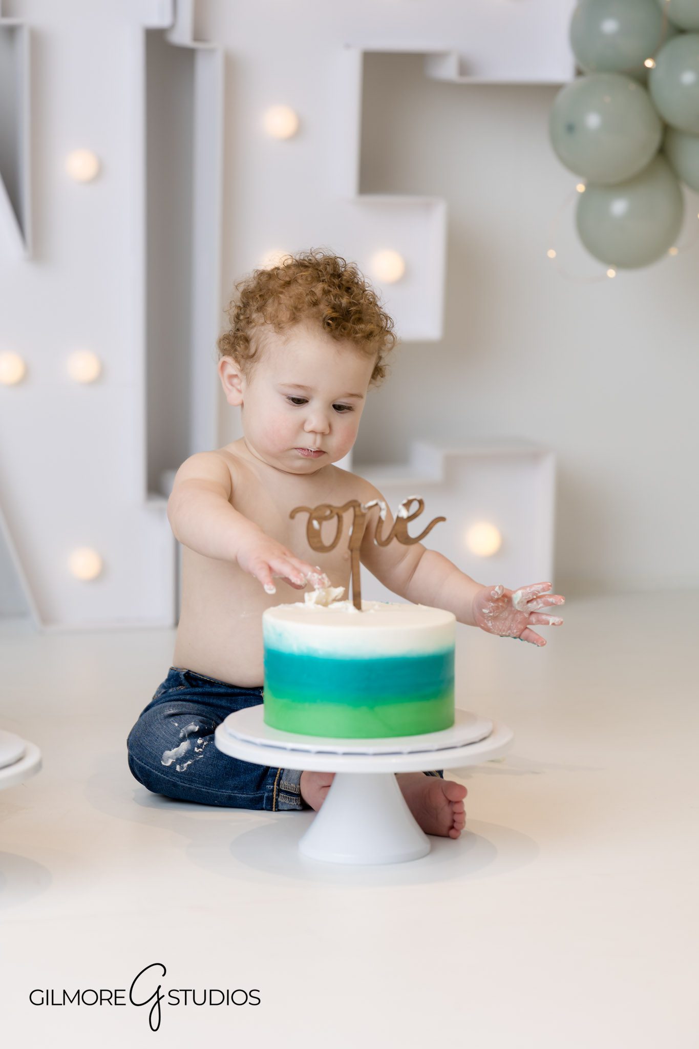 Blue and green cake smash portrait photographer Newport Coast, Newport Coast balloon-themed cake smash photography
