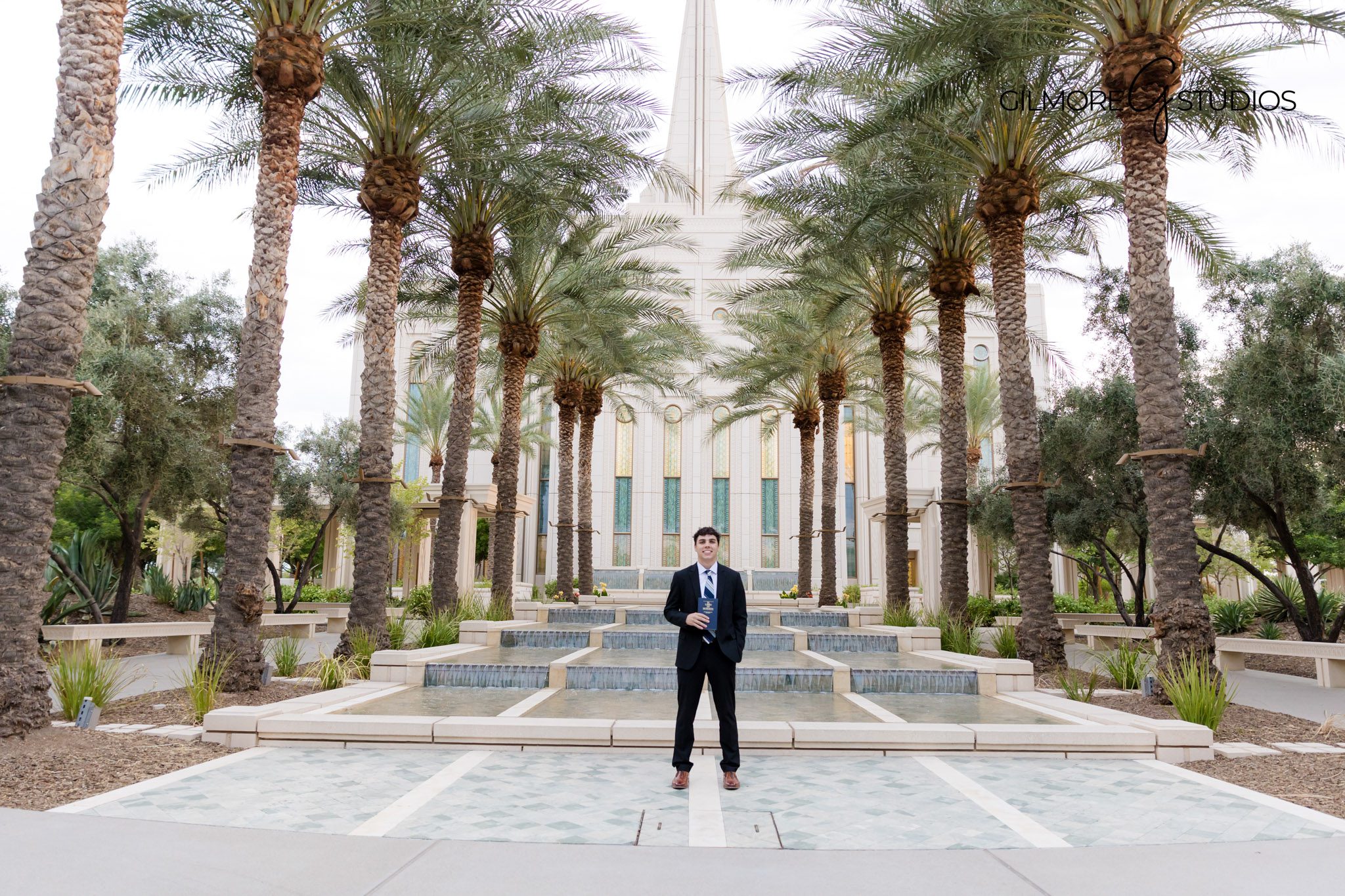 Elder missionary standing in front of Gilbert Temple in white shirt and tie
LDS missionary outdoor portrait session at Arizona Gilbert Temple