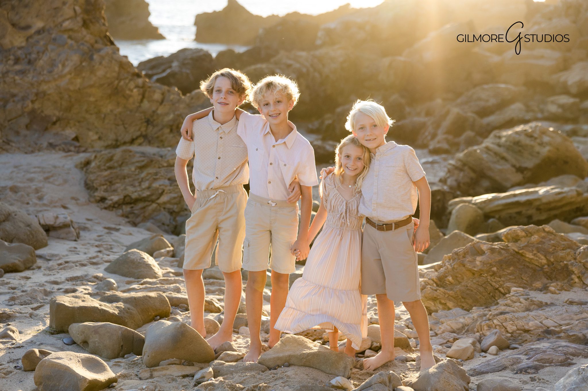 Gilmore Studios beach portraits with family in neutral fall colors
Family laughing together during fall beach photo session Newport Beach