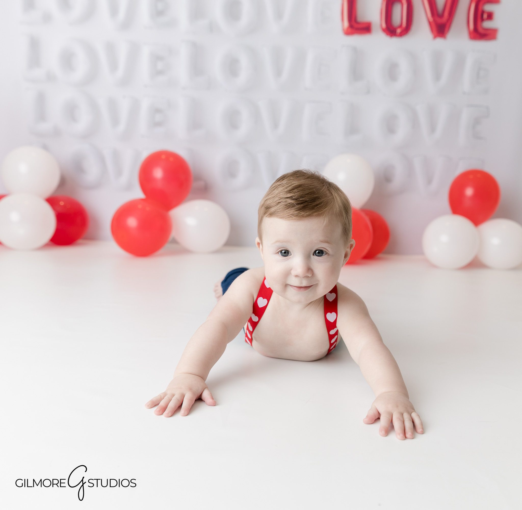 Gilbert Arizona milestone photography session for baby boy in studio
Baby boy wearing romper for milestone photo session Gilbert AZ studio